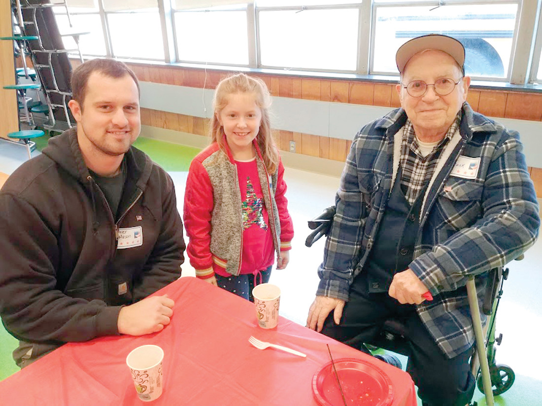 SPECIAL 
NEIGHBORS: WWII Veteran Frank Kay and RI Army National Guard veteran Peter Mason pose with Ellery Shugrue, a second-grader at Glen Hills Elementary School at the morning breakfast before the flag ceremony on Friday.